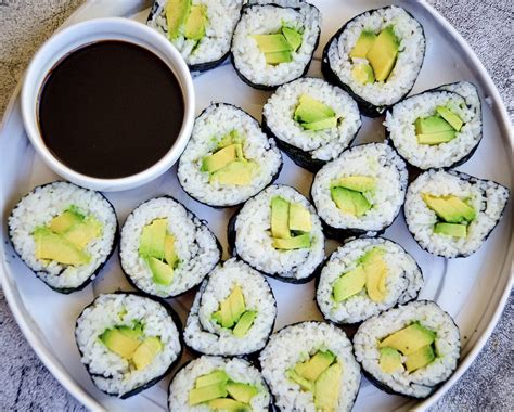 Avocado sushi. Sep 22, 2021 · Make the rolls. Assemble the sushi by placing a nori sheet on a sushi mat. Spread 2/3 cup of the cooked rice over the nori sheet, leaving about 2/3 of an inch clean on one end (see video). Top with some of the avocado and any other veggies you’re using. Roll the nori sheet over top of the fillings and continue to gently and *tightly* roll the ... 