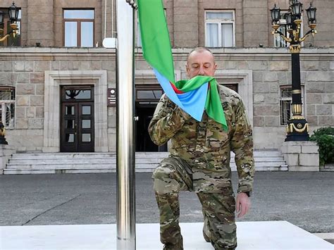 Azerbaijan’s president raises the nation’s flag in a former breakaway region’s capital