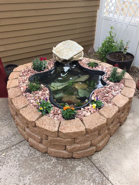 Back yard pond. Place the waterfall spillway near the top and cover it with smaller rocks. Finally, frame the outside edges of the waterfall with large rocks to give it a more natural appearance. Use real stones instead of fake rocks. Soften the edges of the waterfall plants. Add twists and turns to the waterfall. 