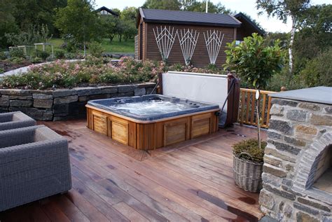 Backyard hot tub. An Asian-inspired hot tub landscaping which can be a great option when you want to have a superb spa nuance in your backyard. The hot tub is ‘planted’ in the center of the wood construction and completed by the wood fence and bamboo gorgeously. (Read also: Wine Bottle Fountain for Sale) Naturally Modern … 