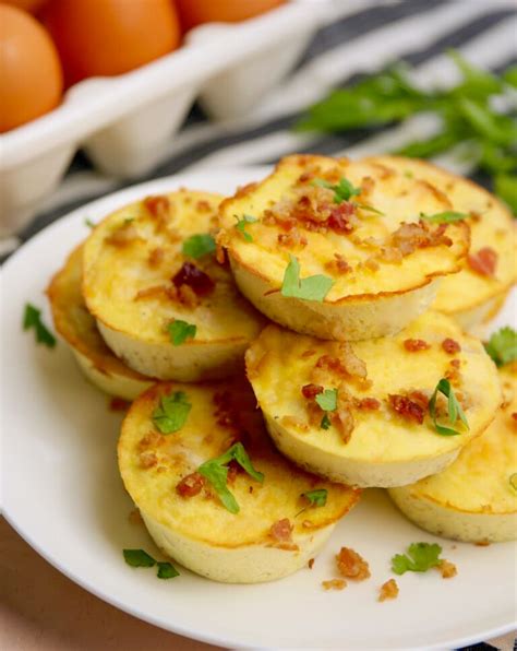 Bacon and gruyere egg bites. Assemble the egg cups. Add ½ a teaspoon of spinach to each of the muffin cups. Chop the bacon, and add the chopped bacon to the spinach layer. Keep 2 slices of bacon to one side for plating/serving. Add a teaspoon of cheese to each cup. Using a container with a spout, pour the egg mixture into each cup. 