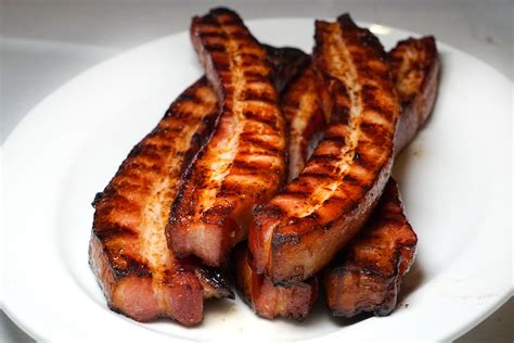 Bacon steak. Cut bacon in half and wrap around steak. Secure with skewer or toothpick. 4. Grease a medium-sized skillet and warm to medium-high heat. Sear steak for 1 to 2 minutes on each side. 5. 