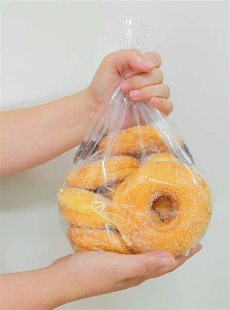 Bag of donuts. Place a large, heavy-bottomed pot over medium heat and add the oil. Clip a kitchen thermometer to the side of the pot, just inside the oil, and heat the oil to 350°F. Fry the Donuts. Line a baking sheet with paper towels, and arrange a cooling rack over it. Place this cooling rack near your frying area. 