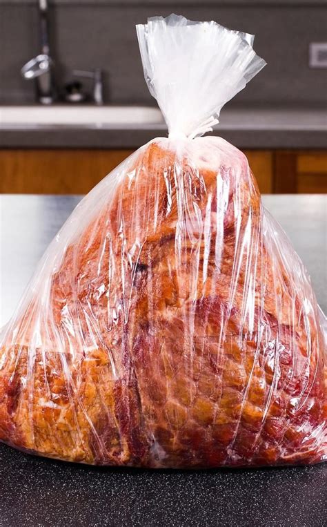Baked ham in cooking bag. 1 approx 8-lb. smoked, ready-to-cook, bone-in ham. In a small bowl, stir together the brown sugar, coke, and mustard to make your glaze. Brush half of the glaze over the ham. Wrap the entire ham well in foil. Place in a 350-degree oven for 1 hour. 1 cup packed brown sugar, 2 tablespoons coke, 1 tablespoon yellow mustard. 