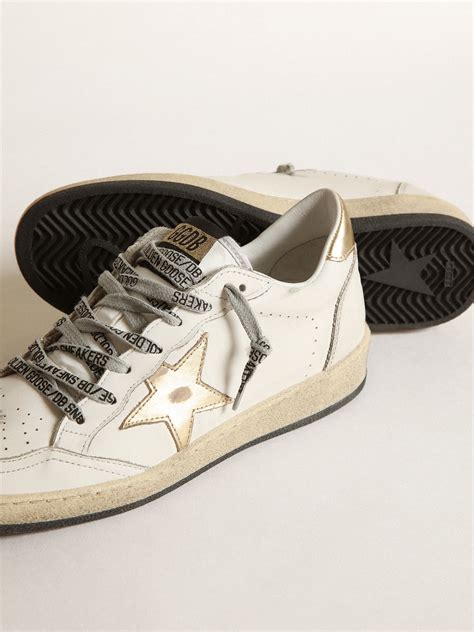 Women’s Ball Star sneakers in milk-white nylon with white leather star and milk-white leather heel tab £415 Ball Star sneakers in white nappa leather with silver glitter star and fluorescent lobster-colored suede inserts. 