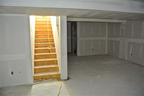 Basement drywall. Steps for Installing Basement Insulation. After the cement is set, apply a foam board adhesive to the rear of a polystyrene insulation panel, then press the panel to the wall. Make sure your adhesive is free of solvents, which can eat away at the foam insulation. Adhere and apply the remaining panels. 