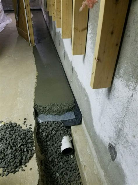 Basement french drain. A French drain is a type of drainage system that consists of a gravel-filled trench, perforated pipe, and filter fabric. It is designed to direct surface water away from a desired area, such as a foundation or basement. … 