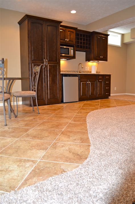 Basement tile flooring. Cork flooring is available in tiles or panels, and comes in many textures and patterns. When it comes to choosing cork flooring in a basement, there are several benefits, including the fact that while cork is durable, it allows for a good amount of cushioning. It can also help to increase the temperature in a space that is often the coldest ... 