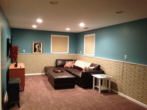 Basement wall paint. Painting with a paint specifically suited to basement walls will reduce dust and mold, probably smell too. If you don't want to spend a lot then wait for lumber prices to drop before doing any framing. Adding walls gives you a opportunity to add wiring without surface mounting conduit. 
