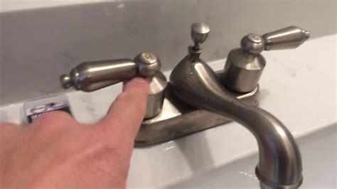 Bathroom faucet leaking at base. Shut off the water supply. Cover drain opening so parts won’t fall into it. If you have lever handles, loosen the set screw with an Allen wrench. 3/32" is the most common size. And then remove the handle. If you have knob handles, carefully pry off the handle button. Then remove the screw using a Phillips screwdriver, and lift off the handle. 