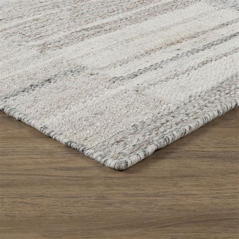 Description. Bring a bit of breezy, coastal style to any room in your home with this natural, handmade area rug. Its understated taupe hue is paired with textured, woven details for a casual, lived-in look. Since this rug is handwoven from reliable, 100% jute with a medium 0.8" pile height, it’s well suited to sit in high-traffic rooms like .... 