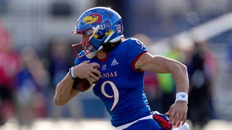 Kansas quarterback Jason Bean gets past Oklahoma State safety Jason Taylor II (25) on his way to a touchdown during the second quarter on Saturday, Nov. 5, 2022 at Memorial Stadium.. 