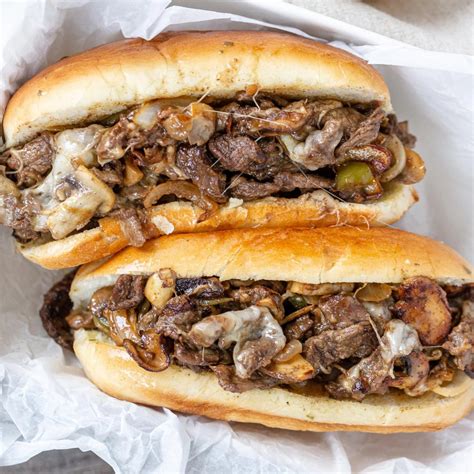 Best cheese for philly cheesesteak. Instructions. Melt the butter over medium heat and add the sliced onions, separating them into rings. Cook until slightly limp and brown. You want them to have a bit of a crunch. Remove onions with a fork and place in the well of the hoagie rolls. Place onion-stuffed hoagie rolls on a baking sheet. 