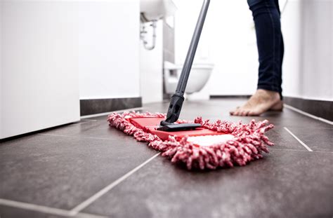 Best cleaner for tile floors. Fill a spray bottle with a half-and-half solution of vinegar and warm water. Spray the mixture on the grout, let it stand for 5 minutes, then scrub the surface with a stiff brush. Avoid using ... 