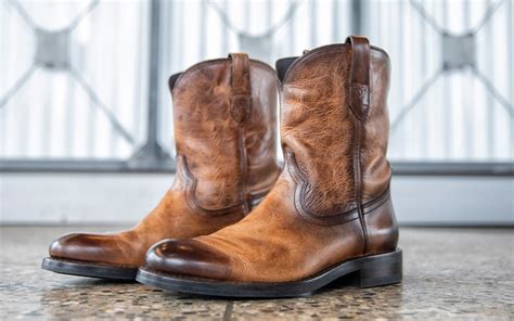 Best mens cowboy boots. Here are some of our favorite men’s cowboy boots for wide feet: 1) Ariat Groundbreaker Work Boot: Style: Roper. Toe Shape: Round. Width: EE - Wide and D - Medium. 2) Ariat Workhog Waterproof Work Boot: Style: Roper Work Boot. Toe Shape: Wide Square. Width: EE - Wide and D - Medium. 