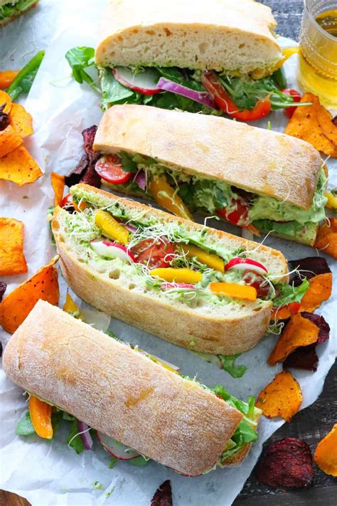 Best vegetarian sandwiches. Open up the bread and spread both sides with mustard. On one side of the bread place a slice or two of cheese, then top with a layer each of tomato, cucumber, radish, carrot, and spinach. Top with the remaining side of bread and eat immediately or wrap tightly in plastic wrap and keep cool for a healthy picnic lunch. 