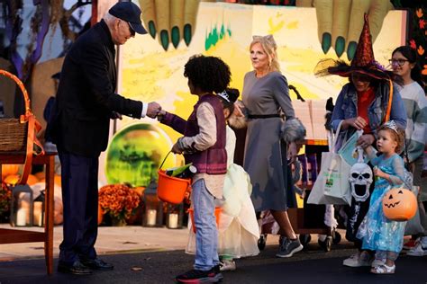 Biden and Jill Biden hand out books and candy while hosting thousands for rainy trick or treating