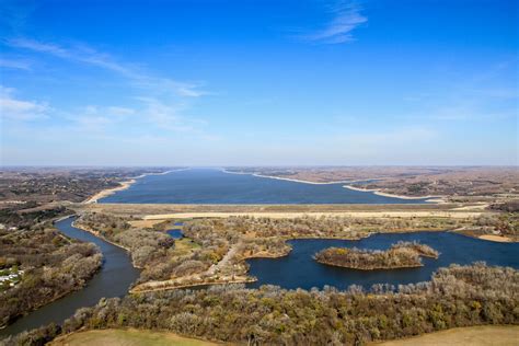 Tuttle Creek Lake, Riley County, Kansas, by Kathy Alexander. Tuttle Creek Lake and State Park is located in the scenic Flint Hills of northeast Kansas. The lake is a reservoir on the Big Blue River five miles north of Manhattan. It provides 12,500 surface acres of water and 100 miles of shoreline, making it the second-largest lake in Kansas.. 