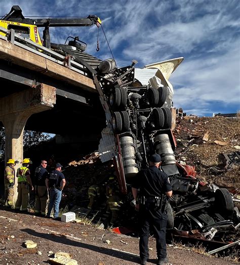 Big rig hangs off I-25 bridge for hours after deadly crash
