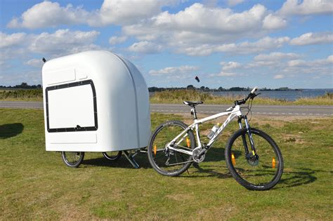 Bike camper trailer. The Nomad bicycle camper was fashioned after the Homeless emergency shelter using just the strength of the arced panels to hold the structure up. This kept construction simple and kept the weight down to 60 pounds, loaded with foam pad, stove, and bins. The front of the camper was rounded for better aerodynamics. 