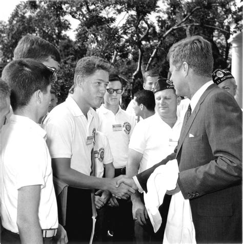 It's an iconic image - Bill Clinton as a teenager shaking hands with President John F. Kennedy in the Rose Garden in 1963. Clinton credited that handshake for inspiring his life in public service.. 