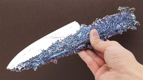 Bismuth knife. Handmade bismuth knife in rainbow color, weighs 308 grams, bismuth is a metal on the periodic table that is eight times rarer than silver that creates a beautiful crystal structure, made by the TheBismuthSmith.com 