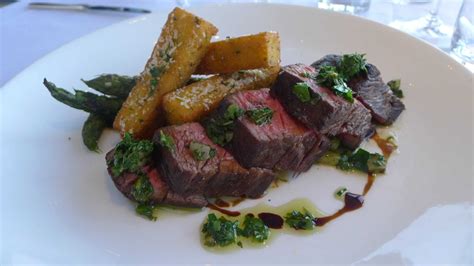 Bistro steaks. Let flames die out, then add red wine and cook until reduced and syrupy, 2 to 4 minutes. Add stock and boil until reduced and thickened, 3 to 4 minutes longer. Remove pan from heat and whisk in remaining 2 tablespoons butter and the chives. Serve steaks and sauce immediately with watercress. 