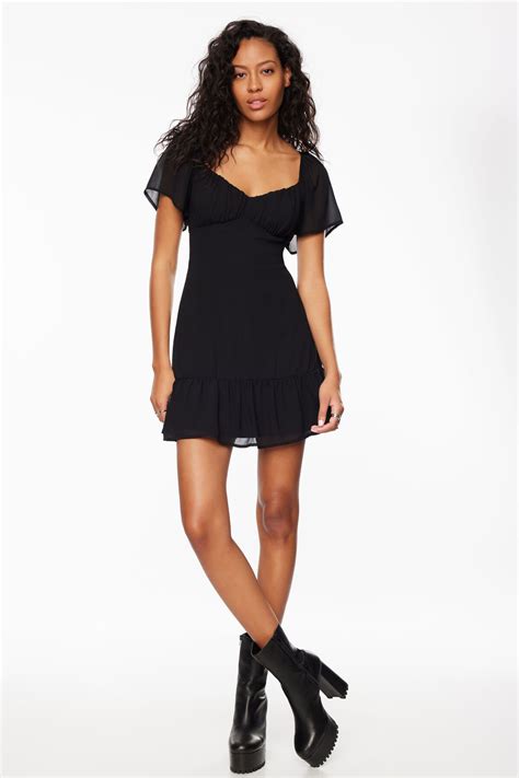 Black dress dynamite.  This chic black mini dress from Dynamite features a...