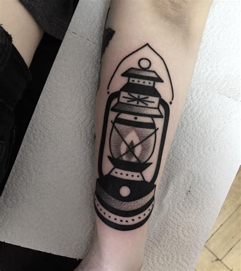 Black lantern tattoo. In addition to the meanings mentioned above, the light in a lantern tattoo can also represent guidance and direction. Just as a lantern illuminates a path in the dark, the light in a lantern tattoo can symbolize a guiding force in one’s life. Furthermore, the lantern itself can hold significance beyond just the light it emits. 