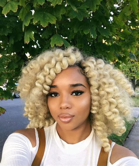 Black people with blonde hair. 3. Turmeric Blonde Hairstyles for Black Women. Source. If you want to go full Marylin Monroe blonde, here is a perfect example of that. In the photo above, she is wearing a turmeric blonde hairstyle with a middle part and curled-out edges, which looks so good. 4. Honey Blonde Hairstyles for Black Women. Source. 