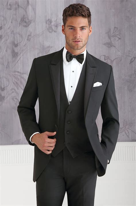 Black suit for wedding. Types of Groomsmen Suits. 1. Tuxedos. Tuxedos are formal suits that are worn for black-tie events. A tuxedo consists of a black jacket and pants, a white dress shirt, a bow tie, and black formal shoes. 2. Three-Piece Suit. A three-piece suit is made up of a jacket, pants, and a waistcoat (also known as a vest). 