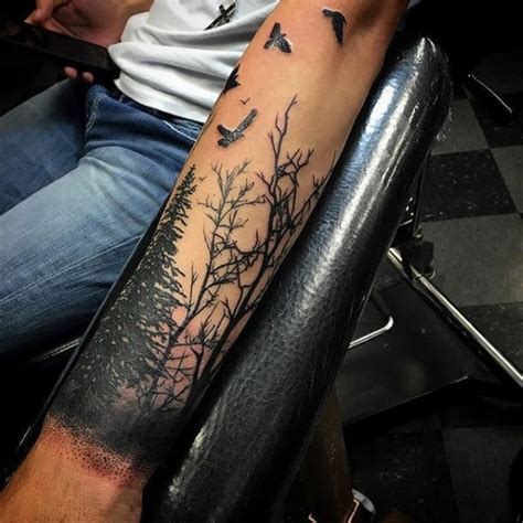 Black tree tattoo on the forearm