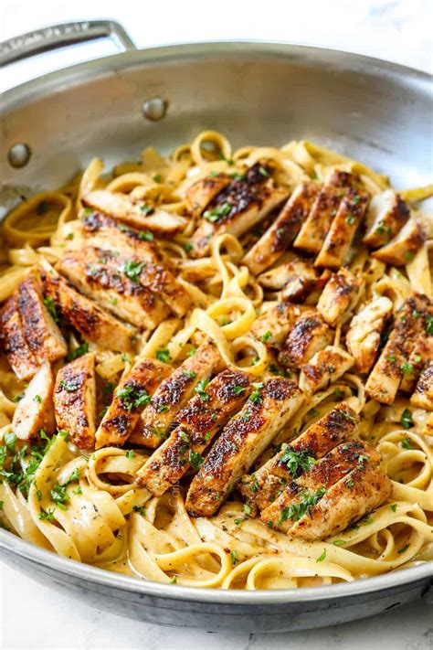 Blackened chicken alfredo. Cajun spices, enough to coat the breasts. 1 pint heavy cream. 4 teaspoons butter. 2 to 4 ounces freshly grated Parmesan cheese. 2 tablespoons butter. Salt and pepper 