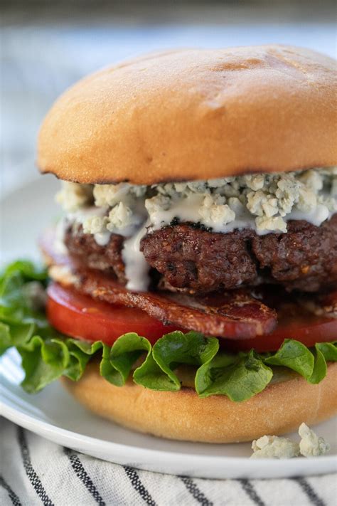 Bleu cheese burger. Applewood Thick Sliced Bacon on top of a 1/4lb Ground Beef Patty topped with Bleu Cheese Crumbles, Freshly Sliced Tomatoes, Iceberg Lettuce, Sliced Onions, and ... 