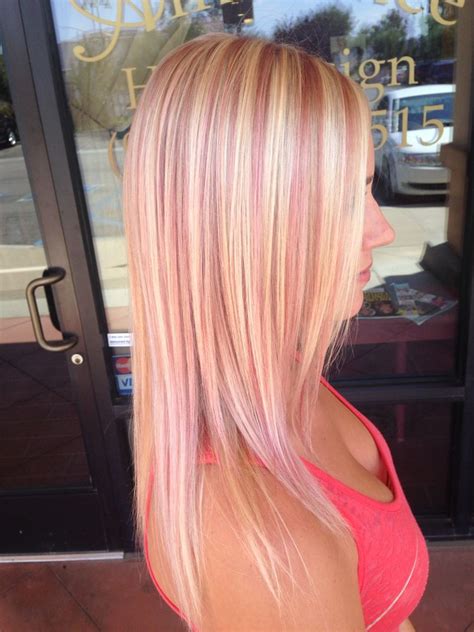 Blonde hair with pink streaks. Bleach always turns red pink. Red is the hardest to strip out of the hair & will always turn red pink. You needed to do some bleach in foil hilights first, ... 