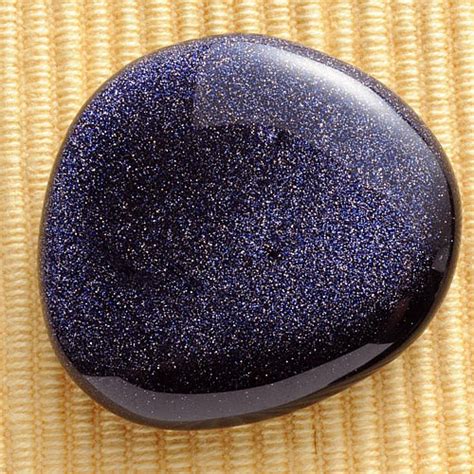 Blue sand stone. Blue sandstone, also known as blue goldstone, is a stunning gemstone that captivates the eye with its deep blue color and glittering inclusions that mimic a starry night sky. This synthetic stone has not only become a favorite in jewelry making but also holds significance in various cultural and metaphysical contexts. 