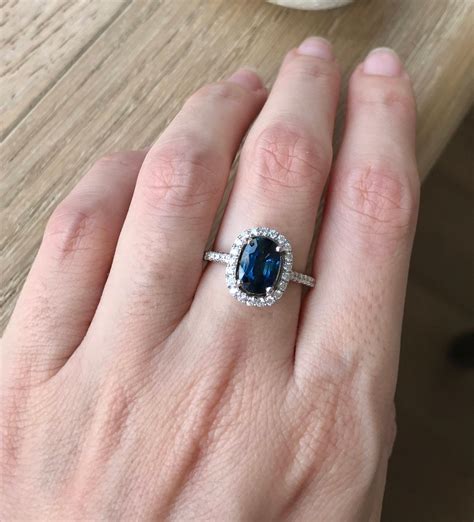 Blue sapphire engagement rings. Sku 17424w14. French pavé set diamonds adds sparkle and brilliance to the band of this classic diamond engagement ring. Vivid blue sapphires frame the center diamond of your choice for a timeless sophisticated touch. Product Details. 