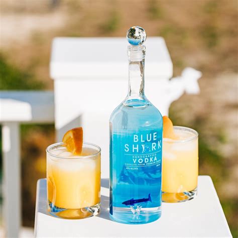 Blue shark vodka. Instructions: Pour 2 ounces of Blue Shark Vodka, followed by a splash of ginger ale, and juice from 1/2 lime over ice. Garnish with a slice of lime. Previous Shark on the Beach. Next The Blue Shark Fin. 