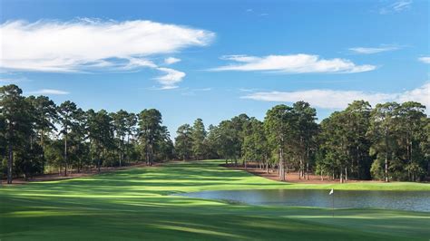 Bluejack national. The concept is, dad can tee off and then the kids can hit in from approx. where his tee shot lands. 1st hole photo courtesy of Bluejack National. The first hole is a dogleg left with a bunker on the outside elbow and water on the inside. The 2nd hole is a reachable dogleg left par 5. 