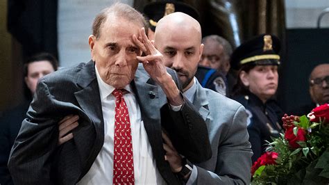 Bob Dole recuperates from injuries he suffered in Italy during World War II in 1945. ... Dole silently raised his left hand in salute to the flag-draped casket before sitting back down.. 