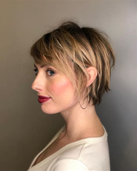 A short bob with side-swept bangs flatters all face shapes. Side-swept bangs on layered bob haircuts highlight your eyes and cheekbones while concealing any signs of harsh lines and angles. Consider a short layered cut to achieve a youthful-looking, edgy finish. Instagram @iamstephmurray.. 