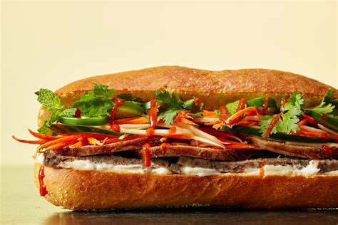Bon banh mi. Line a rimmed baking sheet with aluminum foil and spread the bacon over it. Bake the bacon until crispy, about 15 minutes, then drain on a plate lined with two layers of paper towels. Remove foil from baking sheet and discard it, then place baguettes on the now-empty baking sheet. Toast for 3 minutes until exterior is crispy. 