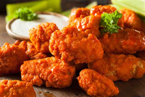 Boneless wings. Boneless chicken wings are a crowd-pleasing favorite, crafted from tender, juicy breast meat, not actual wing meat. These bite-sized delights are breaded and seasoned for a satisfying crunch, offering the wing experience without the bones. Perfect for dipping and sharing, they're a versatile treat for any occasion. 