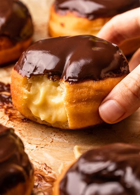 Boston cream doughnut. Pour oil into a deep stock pot at least 2-inches high from the bottom. Heat over medium heat (a #5 or #6 heat on a 10 level dial) until ready to fry. Open a tube of biscuits and fry 5 at a time, turning each piece of dough when golden brown, and removing the donuts when browned on each side. 