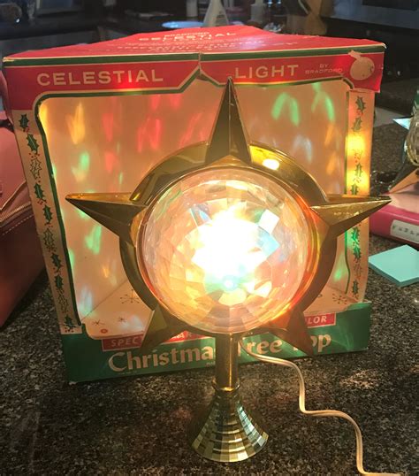 • This is a vintage 1960’s Bradford Celestial Star Tree Topper. The moving center throws colorful star lights around the room. Its such a cool retro piece and is in beautiful working condition! • Can be used as a tree topper or stand on its own with its original green tabletop stand. • To use this