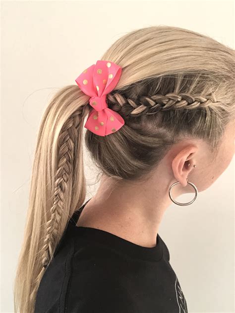 Start by braiding the front until you reach the crown of your head. Then, add some water wave extensions at the back and tie a small portion into a ponytail to poke out at the top. Alternatively, you can hold the entire style in a topknot and have a texture explosion. 6. Winding & Curly Feed-In Braids Ponytail.. 
