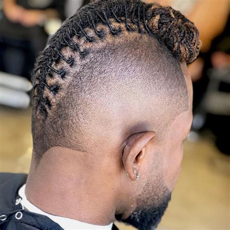 The most popular haircuts for black men include the buzz cut fade, short afro, waves, twists, high top, box braids, tight curls, cornrows and locs. These stylish and modern black hairstyles generally feature a fade on the sides and back with short to medium-length afro-textured hair on top for a fashionable look.