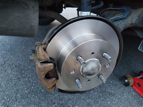 Brake pad and rotor replacement. To replace a brake rotor, the wheel, brake caliper, and a retaining screw must be removed from the vehicle. The replacement rotor is installed by sliding onto the hub and bearing assembly, and cleaned before installing the brake caliper and brake pads. Wheel nuts, also called lug nuts, must be tightened to the manufacturer specification. 