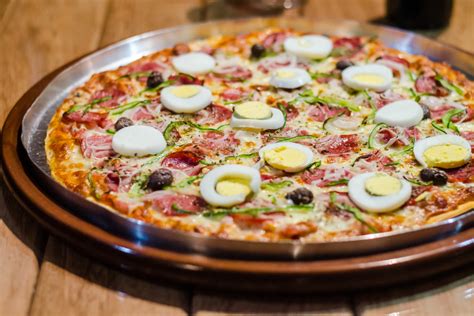 Brazilian pizza. Take-out pizza from locations like Pizza Hut and Dominoes can be left out unrefrigerated for up to 24 hours. Pizza tends to become dry and hard when it sits at room temperature for... 