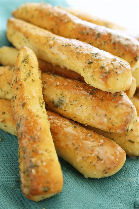 Breadstick. Directions. Split buns in half; cut each half length-wise. Combine butter and garlic; brush over breadsticks. Place on a greased 15x10x1-in. baking pan. Bake at 325° for 25-30 minutes or until golden brown. Editor's Note: Breadsticks may also be baked at 250° for 60-70 minutes. 
